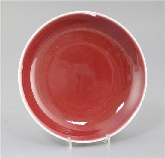A Chinese sang de boeuf dish, Qianlong mark and probably of the period (1736-1795), diameter 19cm, rim chip